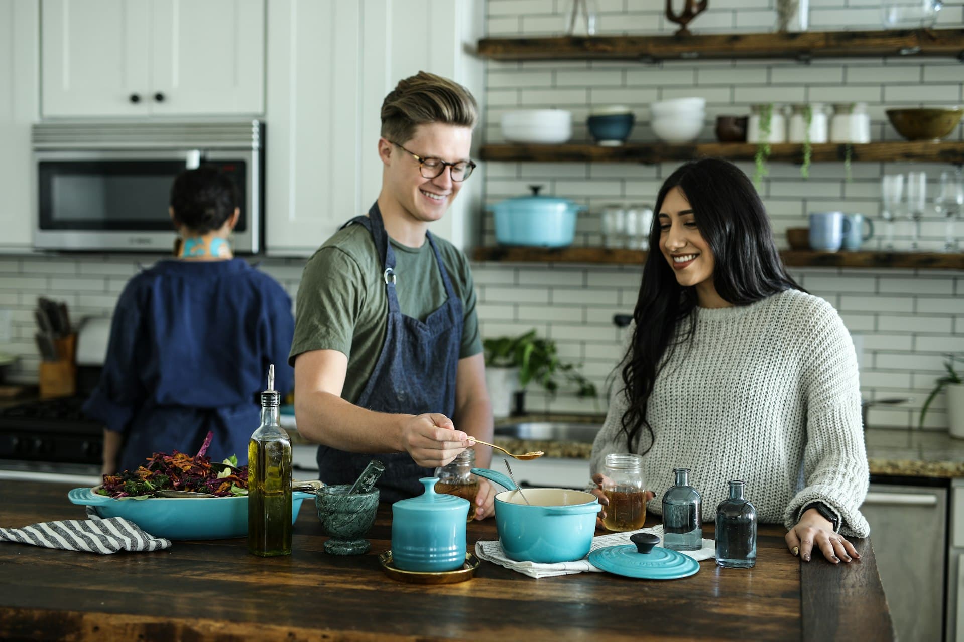 Friends cooking together at a kitchen counter